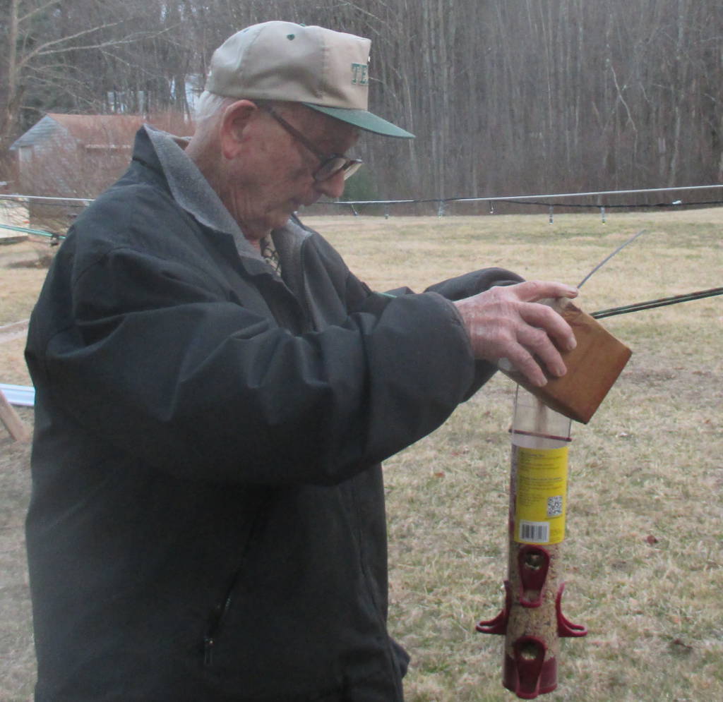 filling birdfeeder